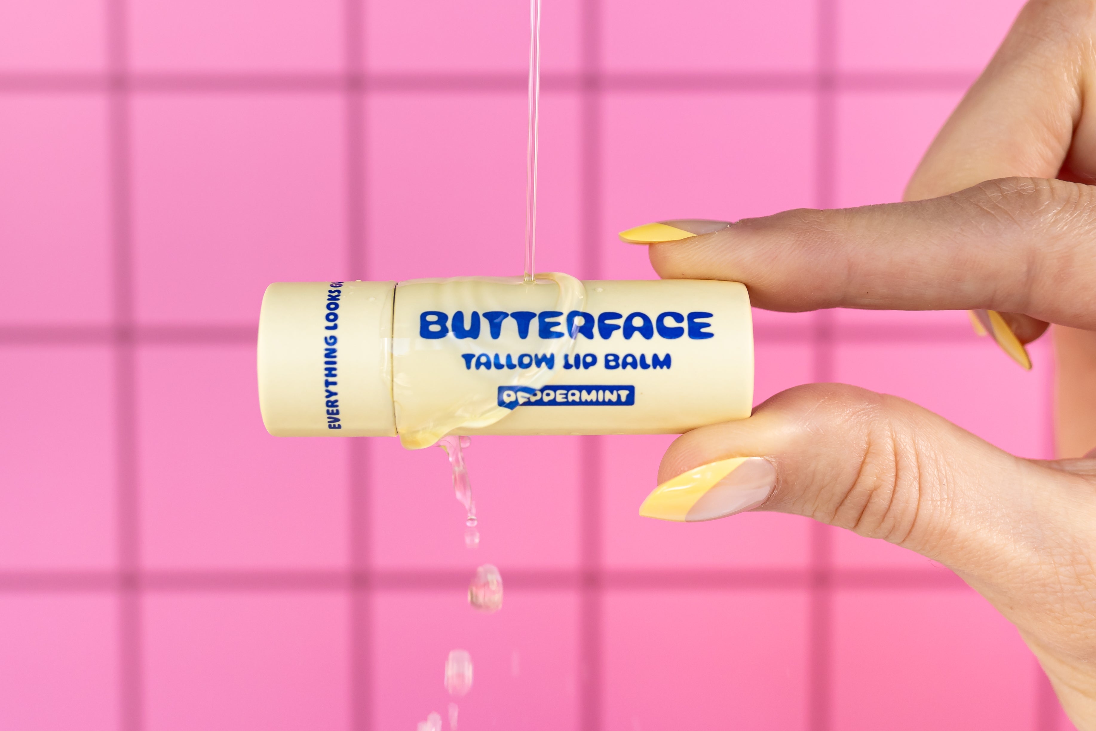 Butterface Tallow Hydrating Lip Balm against pink check background